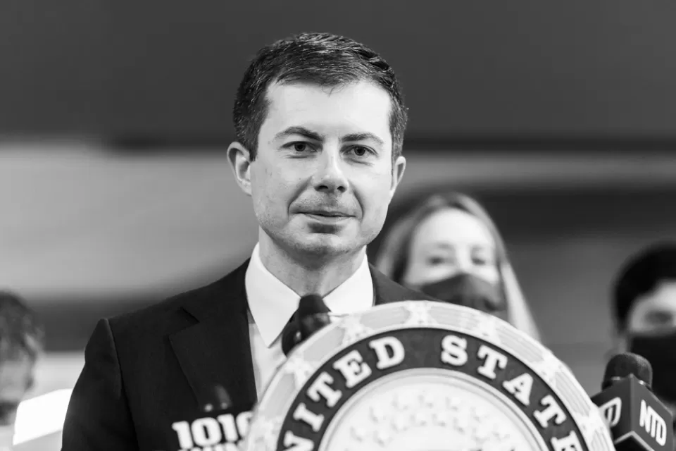A black and white photo of U.S. Transportation Secretary Pete Buttigieg.